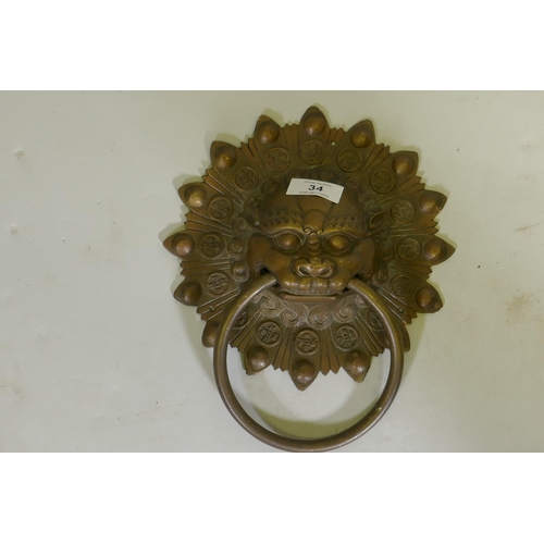 34 - A Chinese lion mask bronze door knocker, 25cm long