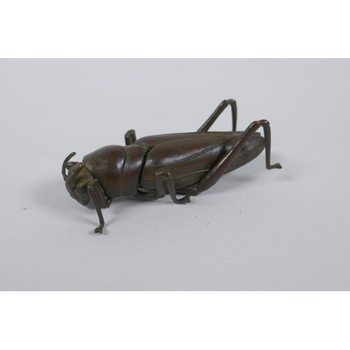 38 - A Japanese Jizai style okimono grass hopper with articulated limbs and wings, 8cm long