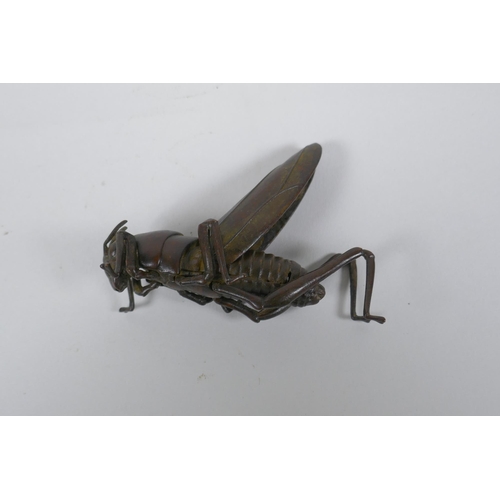 38 - A Japanese Jizai style okimono grass hopper with articulated limbs and wings, 8cm long