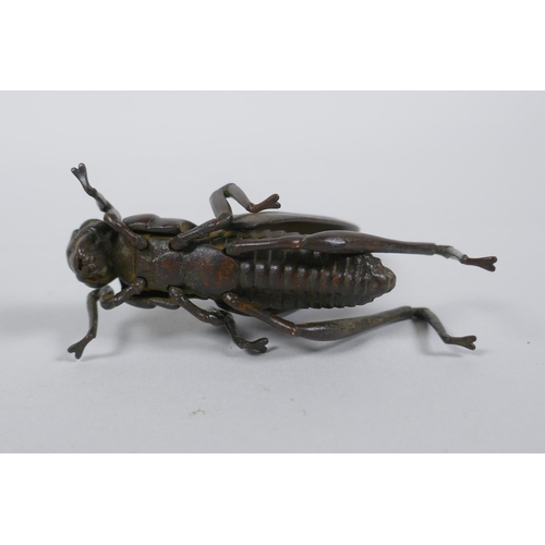 38 - A Japanese Jizai style okimono grass hopper with articulated limbs and wings, 8cm long