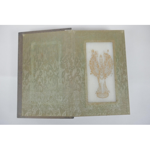 40 - A Chinese wood and silk bound book containing white jade tablet pages with chased and gilt inscripti... 