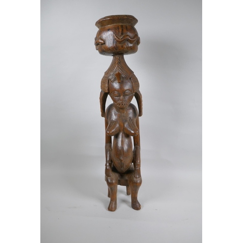 41 - An African carved hardwood Senufo maternity figure, 63cm high