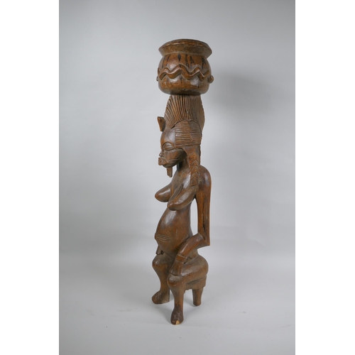 41 - An African carved hardwood Senufo maternity figure, 63cm high