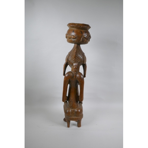 41 - An African carved hardwood Senufo maternity figure, 63cm high