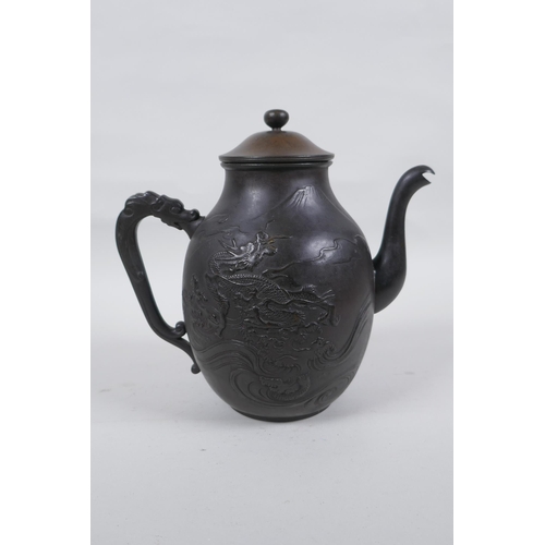 44 - A Japanese bronze teapot with raised dragon and landscape decoration, character mark to base, 20cm h... 