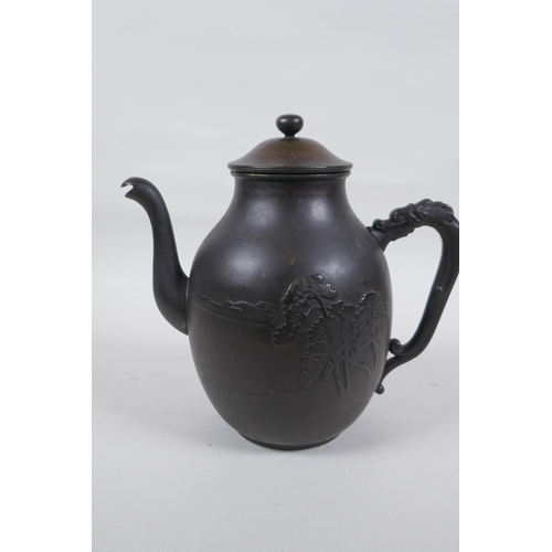 44 - A Japanese bronze teapot with raised dragon and landscape decoration, character mark to base, 20cm h... 