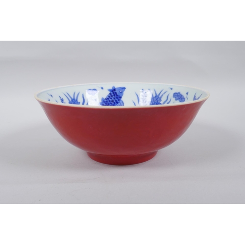 51 - A Chinese porcelain bowl with blue and white decoration to the interior of carp and lotus flowers, t... 