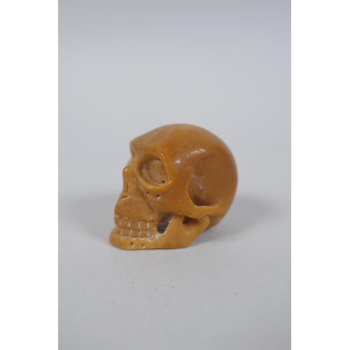 56 - Five Japanese carved tagua nut netsuke in the form of rabbits, rats, monkeys and a skull, largest 4c... 