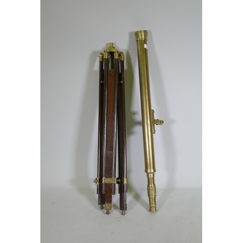 6 - A brass telescope on telescopic wood stand, 98cm long, 104cm high