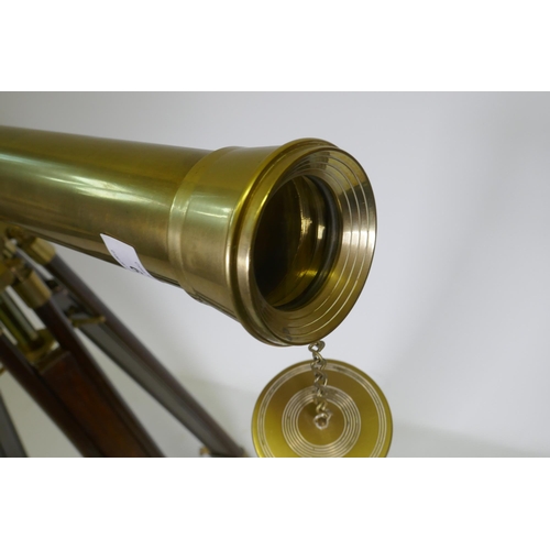 6 - A brass telescope on telescopic wood stand, 98cm long, 104cm high