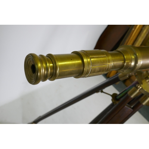 6 - A brass telescope on telescopic wood stand, 98cm long, 104cm high