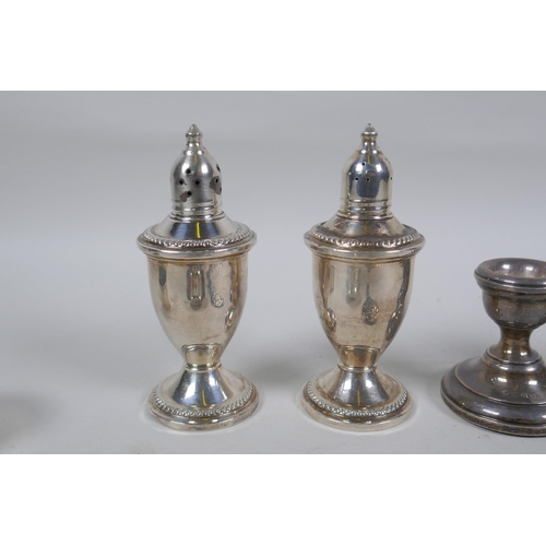 601 - A quantity of hallmarked silver to include a pair of sifters with glass liners, a trinket dish by R.... 