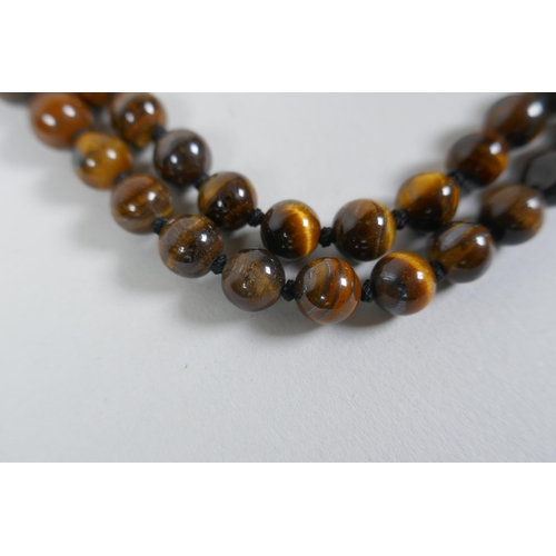 607 - A tiger's eye bead necklace, 96cm long