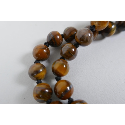 607 - A tiger's eye bead necklace, 96cm long