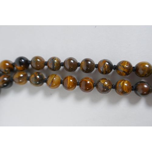 607 - A tiger's eye bead necklace, 96cm long