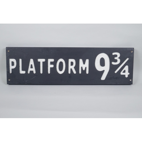 61 - A painted wood Harry Potter 'Platform 9¾' sign, 17 x 59cm long