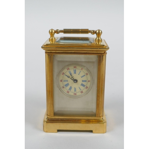 610 - A miniature brass cased carriage clock with Sevres style porcelain panels, 6cm high