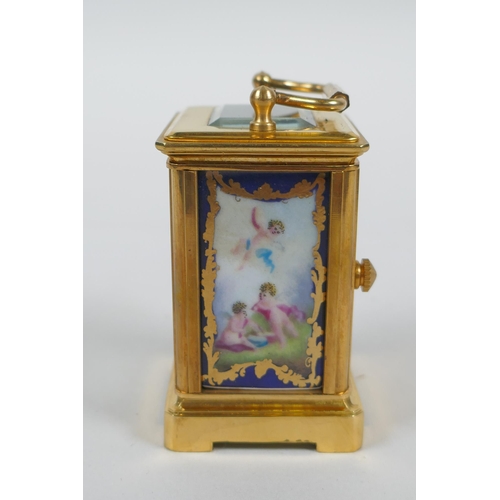 610 - A miniature brass cased carriage clock with Sevres style porcelain panels, 6cm high