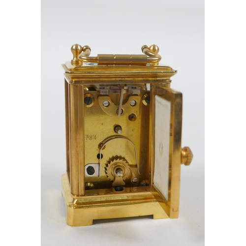 610 - A miniature brass cased carriage clock with Sevres style porcelain panels, 6cm high