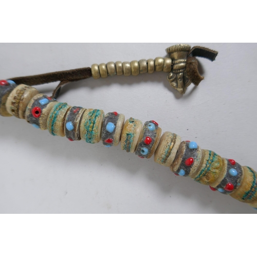 617 - A Tibetan string of stone set bone mala beads, including turquoise, bone, nut, stone etc