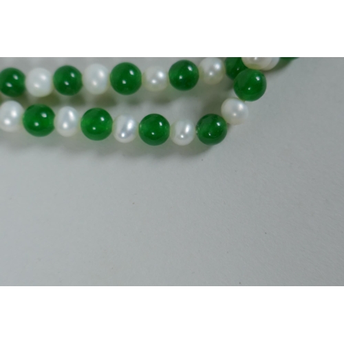 627 - A green hardstone and faux pearl bead necklace, 120cm long