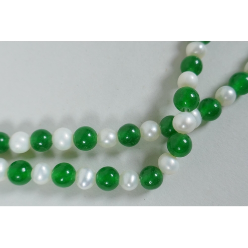 627 - A green hardstone and faux pearl bead necklace, 120cm long