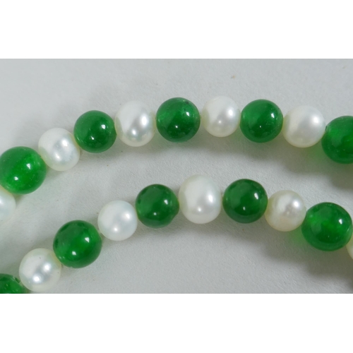 627 - A green hardstone and faux pearl bead necklace, 120cm long