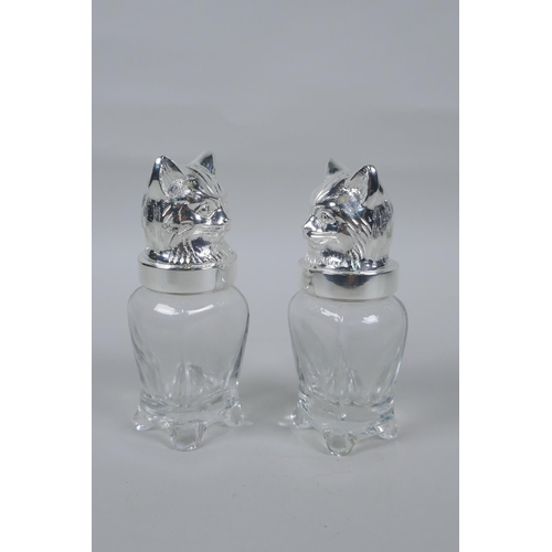 634 - A pair of silver plated and glass salt and pepper shakers in the form of cats, 12cm high