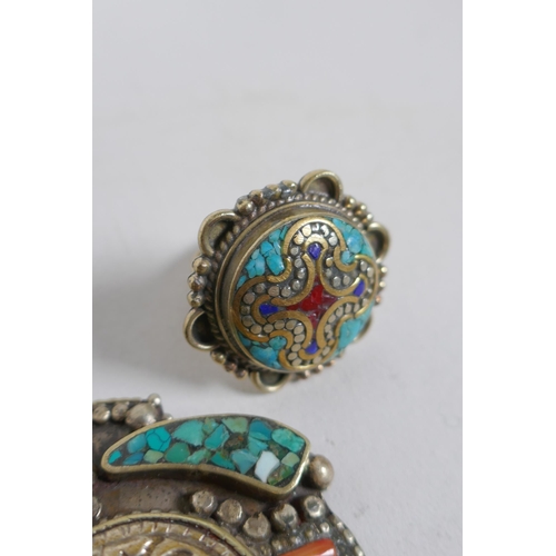 636 - A collection of Tibetan coral and turquoise set gilt metal pendants and rings