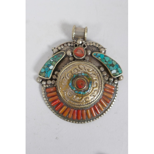 636 - A collection of Tibetan coral and turquoise set gilt metal pendants and rings