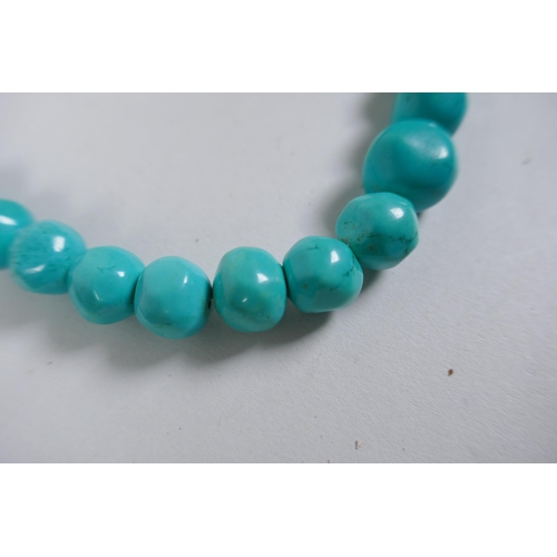 638 - A string of graduated turquoise beads, together with a string of amber agate beads