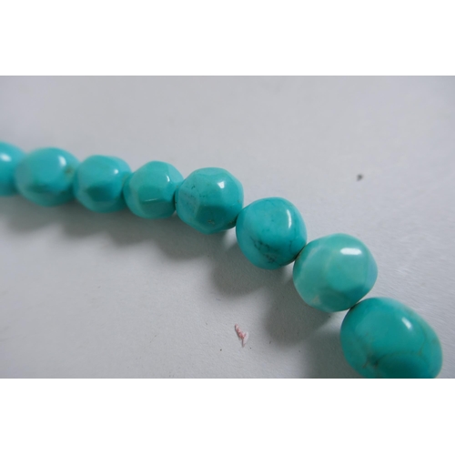 638 - A string of graduated turquoise beads, together with a string of amber agate beads