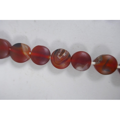 638 - A string of graduated turquoise beads, together with a string of amber agate beads