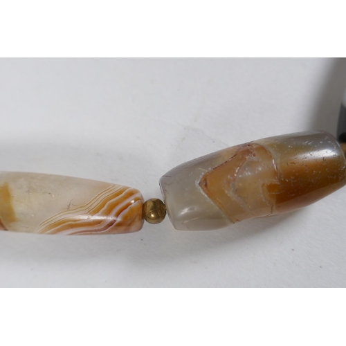 642 - A string of graduated banded agate beads, 66cm long