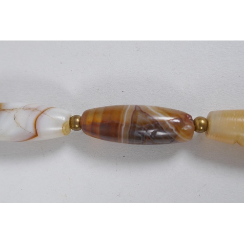 642 - A string of graduated banded agate beads, 66cm long