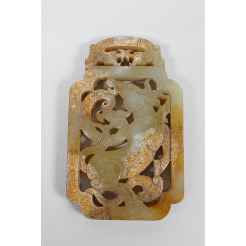 67 - A Chinese carved and pierced jade scroll weight decorated with a buffalo and dragon, 5 x 8.5cm