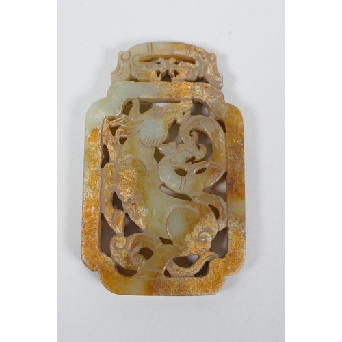 67 - A Chinese carved and pierced jade scroll weight decorated with a buffalo and dragon, 5 x 8.5cm