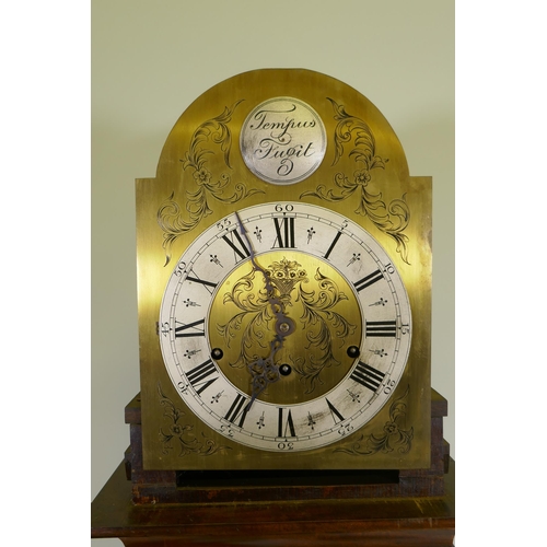 670 - A mahogany cased grandmother clock with brass dial,  silvered metal bezel and Roman numerals, the mo... 