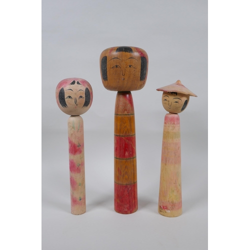 76 - Three Japanese Kokeshi dolls, largest 25cm high