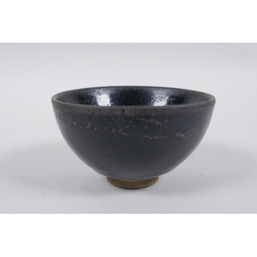 77 - A Chinese Jian Kiln tea bowl with hares fur glaze, and another with a treacle glaze, 9cm diameter