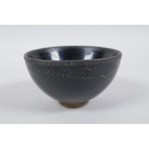 77 - A Chinese Jian Kiln tea bowl with hares fur glaze, and another with a treacle glaze, 9cm diameter