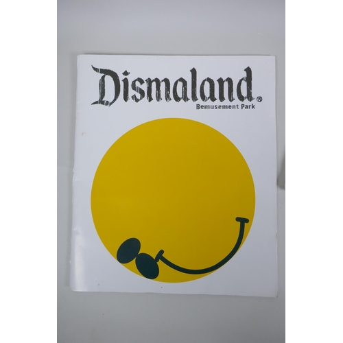 825 - After Banksy, a Dismaland brochure, Dismaland T-shirt (child size M), and two FCK-PTN! postcards, an... 