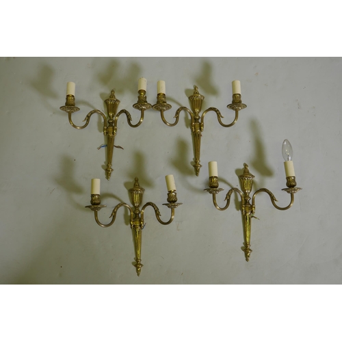 83 - A set of four gilt brass two branch wall lamps, 34cm long