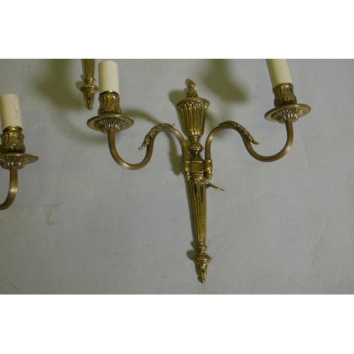 83 - A set of four gilt brass two branch wall lamps, 34cm long