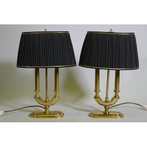 86 - A pair of brass two branch table lamps with pleated shades, 49cm high with shades