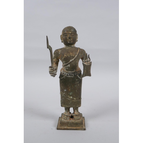 9 - An antique South Indian bronze figure carrying Theyyam sword and shield, 19cm high