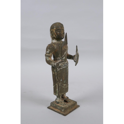 9 - An antique South Indian bronze figure carrying Theyyam sword and shield, 19cm high