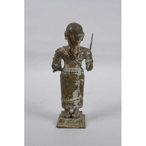 9 - An antique South Indian bronze figure carrying Theyyam sword and shield, 19cm high