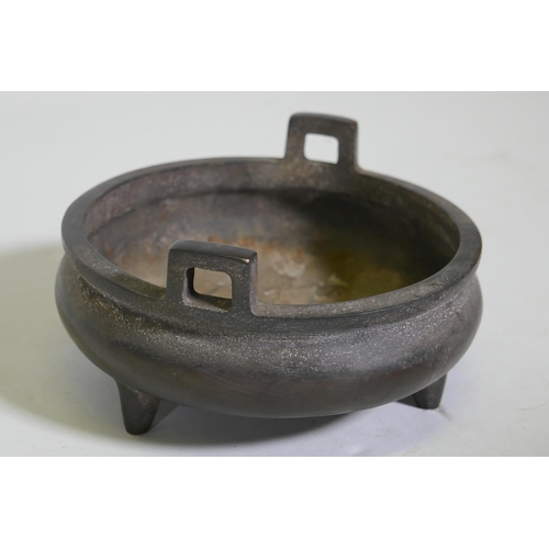 91 - A Chinese bronze censer with two handles and seal mark to base, 15cm diameter