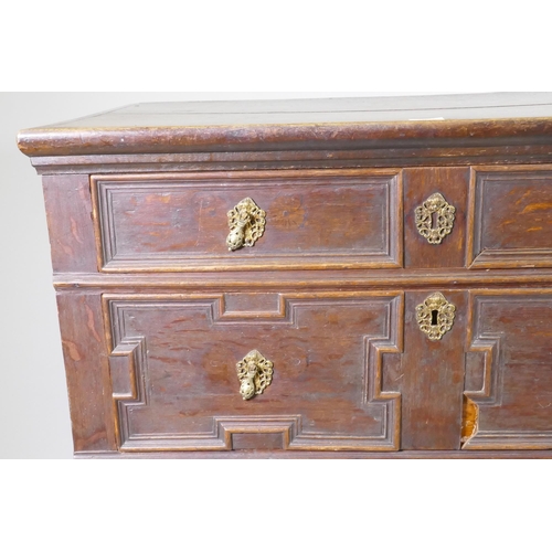 1126 - A late C17th/early C18th oak garret chest of four drawers, raised on bun feet, with adaptions, 95 x ... 